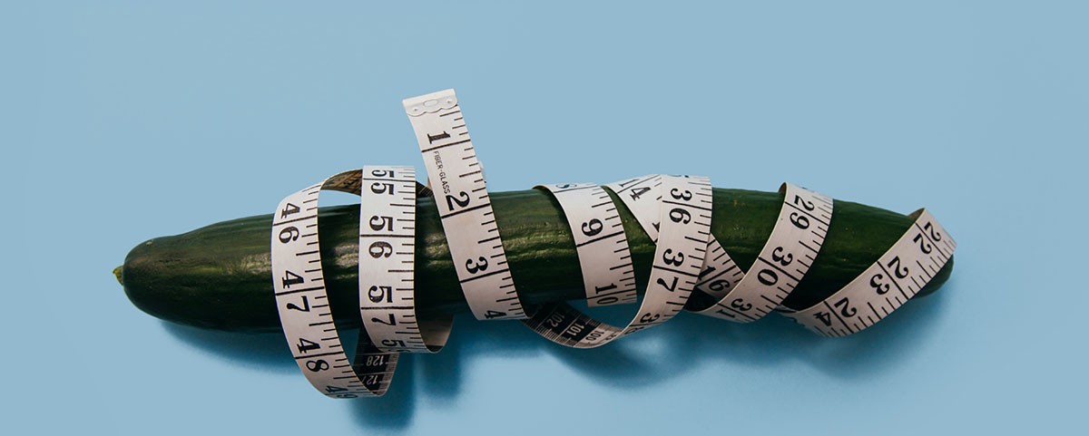 cucumber tied with measuring tape as penis